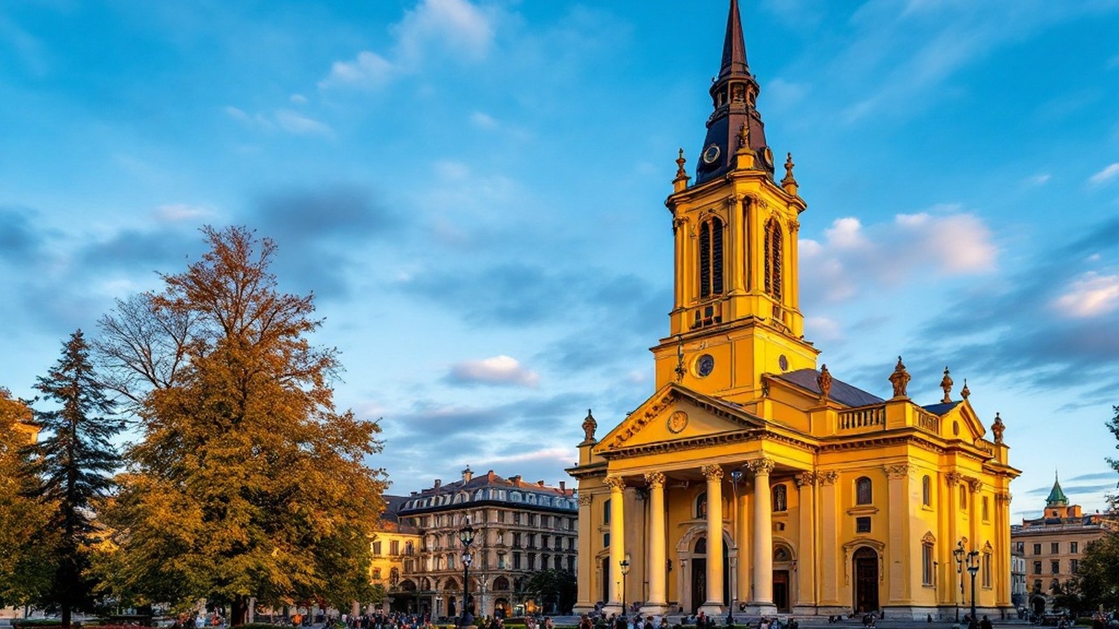 The yellow neoclassical Reformed Great Church on Kossuth Square, Debrecen, at golden hour